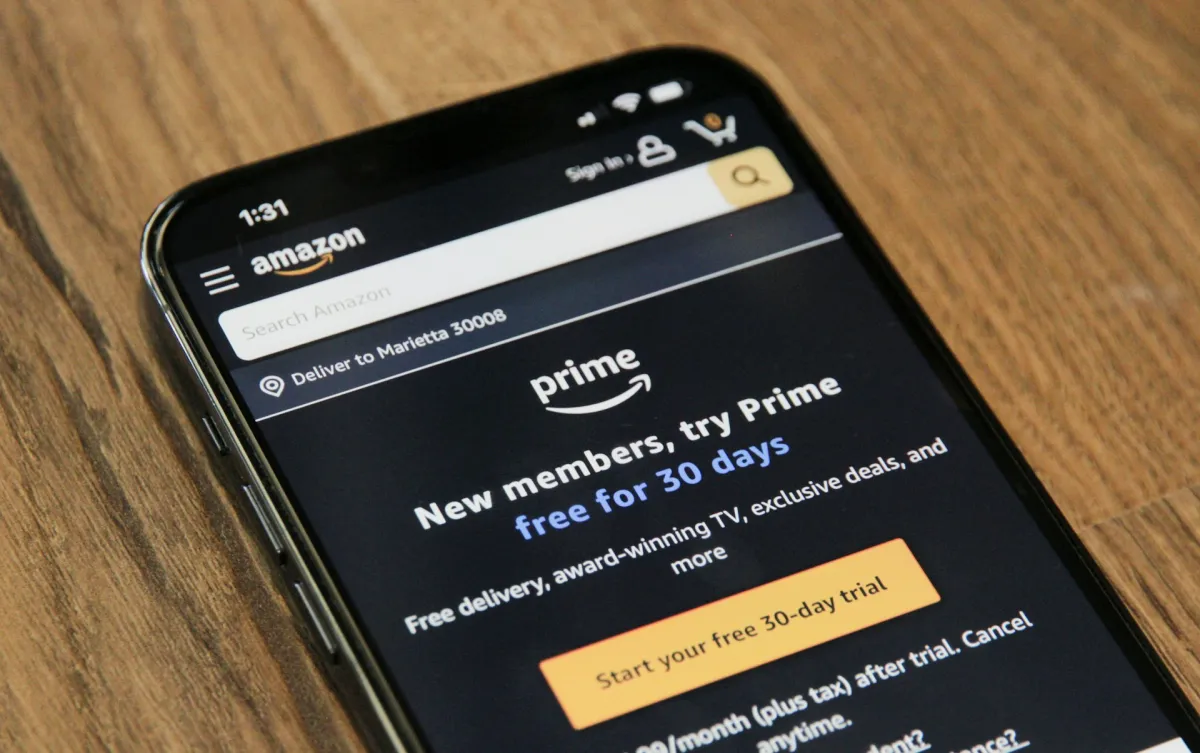Amazon app on a phone promoting a free 30-day Prime trial before recurring monthly billing begins